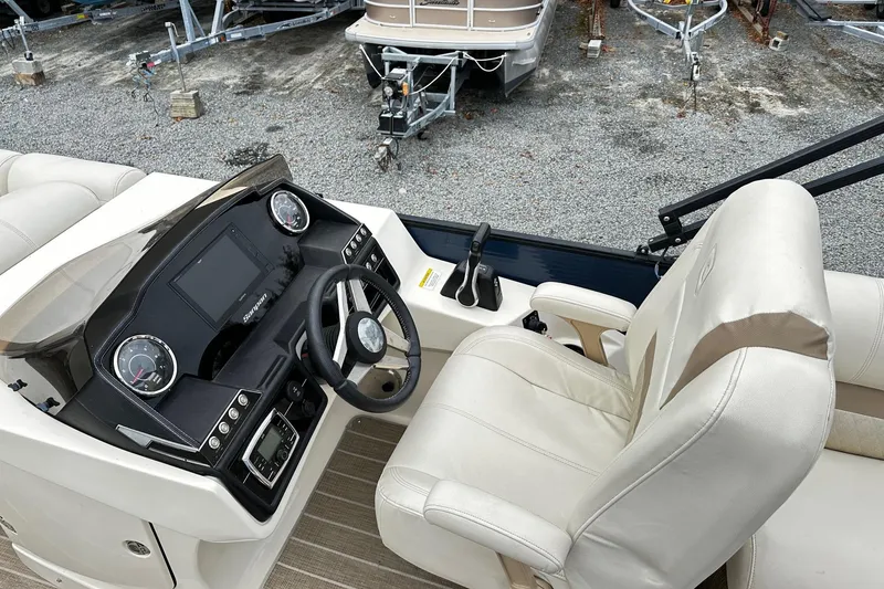Slide: The Image of 2018 Godfrey San Pan Tri Toon boat cockpit with steering wheel and control panel. - 3