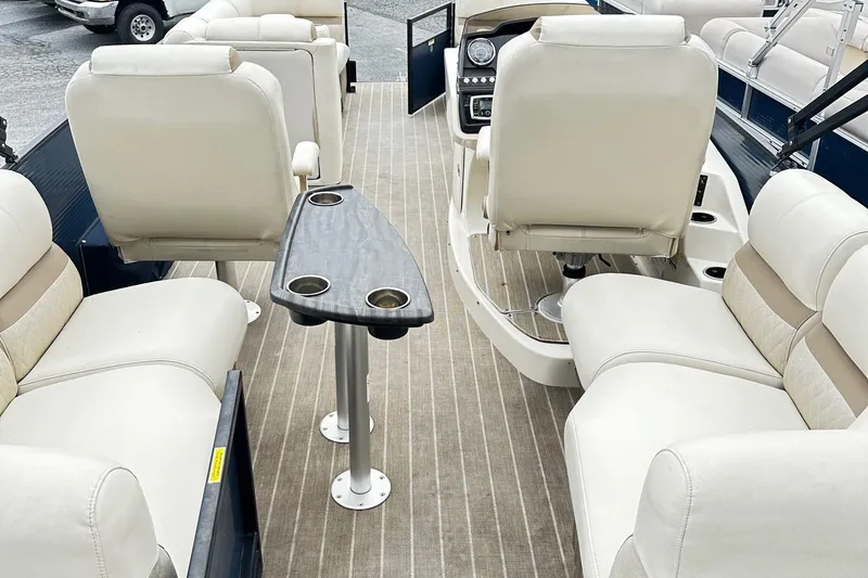 Slide: The Image of 2018 Godfrey San Pan Tri Toon boat with beige and tan cushioned seating. - 7
