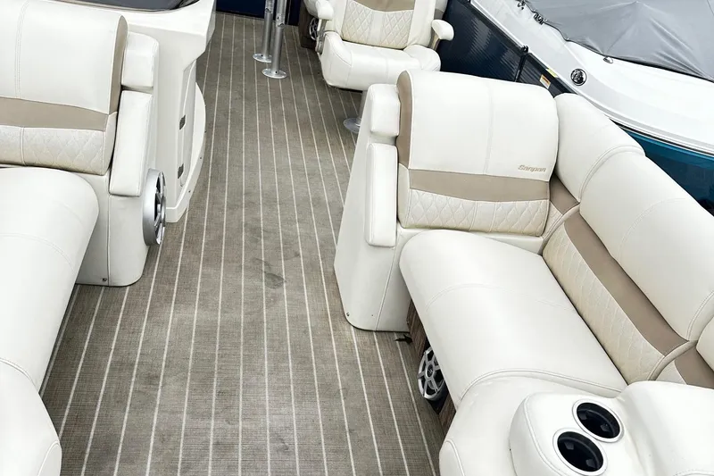 Slide: The Image of 2018 Godfrey San Pan Tri Toon boat interior with plush seating and table. - 8