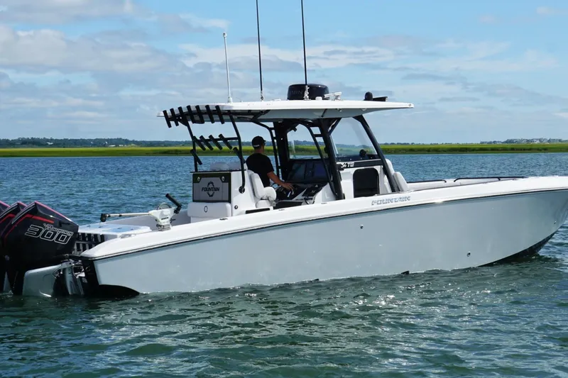 Slide: The Image of 2024 Fountain 34 TE boat cruising on calm water under a clear sky. - 10