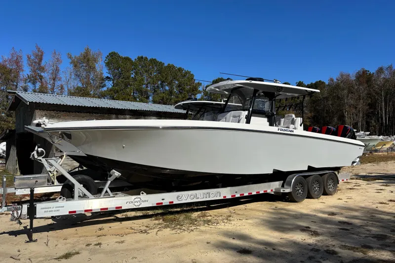 Slide: The Image of 2024 Fountain 34 Tournament Edition boat on trailer, parked outdoors. - 16