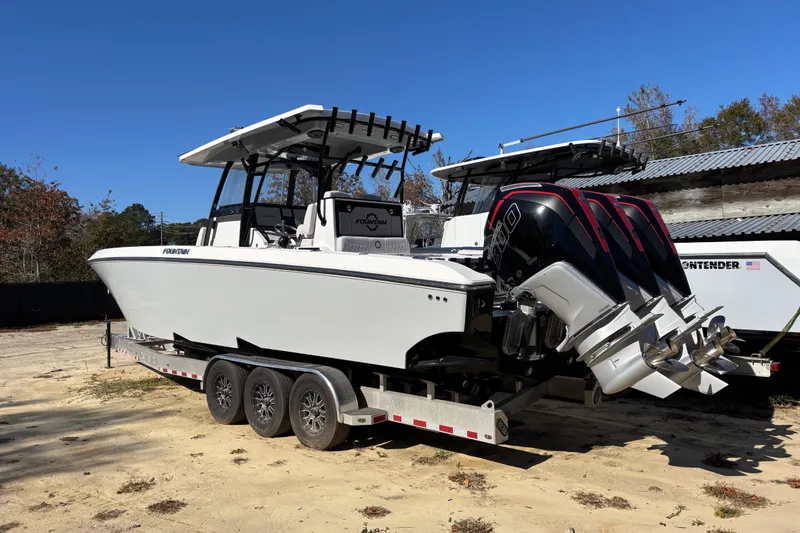 Slide: The Image of 2024 Fountain 34 Tournament Edition boat on trailer with triple outboard engines. - 17