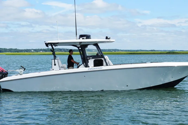 Slide: The Image of 2024 Fountain 34 TE boat cruising on calm water under a clear sky. - 4