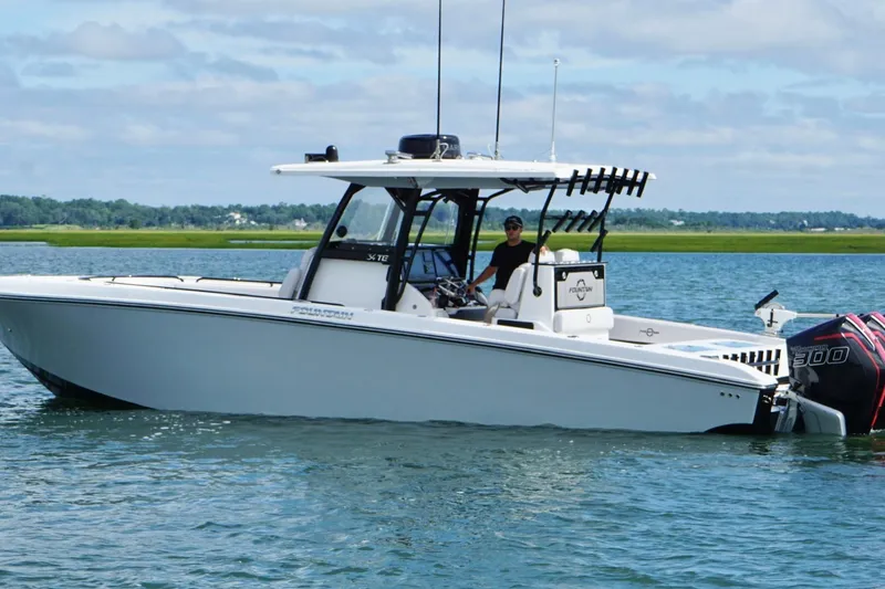 Slide: The Image of 2024 Fountain 34 TE boat on water, featuring dual outboard engines. - 7