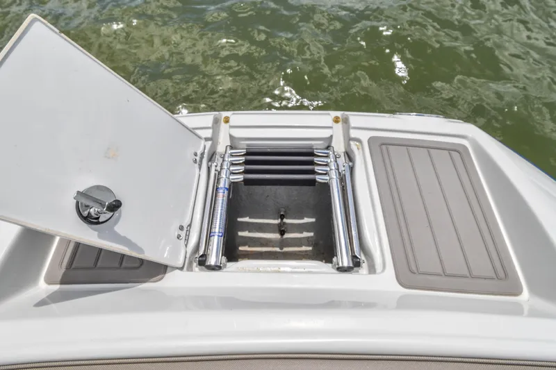 Slide: The Image of 2019 Crownline Eclipse E255 SURF boat with open swim platform ladder. - 14