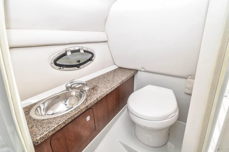 Slide: The Image of 2019 Crownline Eclipse E255 SURF boat bathroom with sink and toilet. - 15