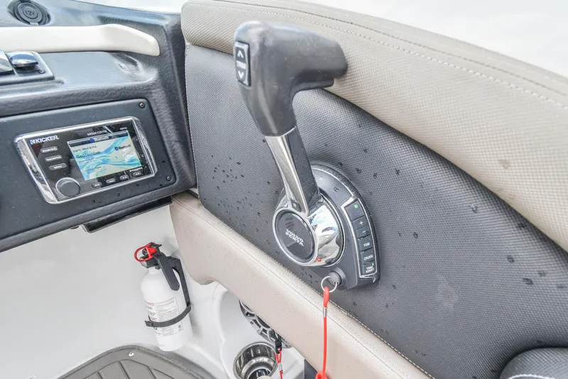 Slide: The Image of 2019 Crownline Eclipse E255 SURF boat controls with Kicker media center and throttle lever. - 21