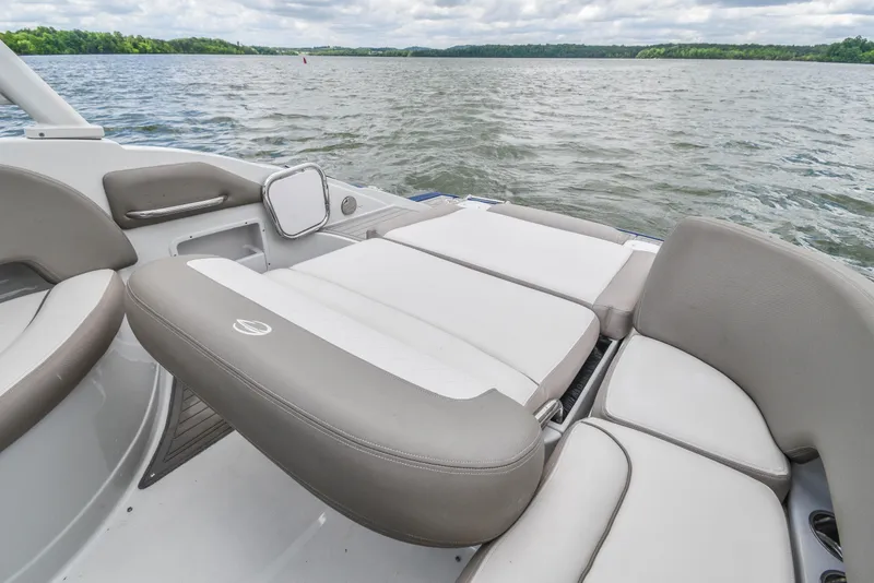 Slide: The Image of 2019 Crownline Eclipse E255 SURF boat interior with comfortable seating on a lake. - 22