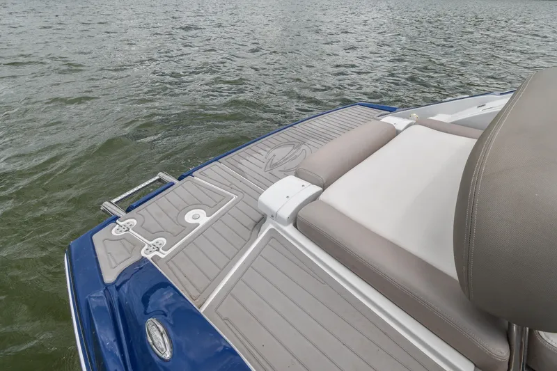 Slide: The Image of 2019 Crownline Eclipse E255 SURF boat deck with cushioned seating and water view. - 24