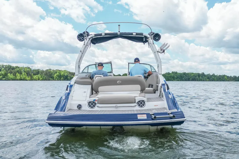 Slide: The Image of 2019 Crownline Eclipse E255 SURF boat on a lake with two passengers. - 3
