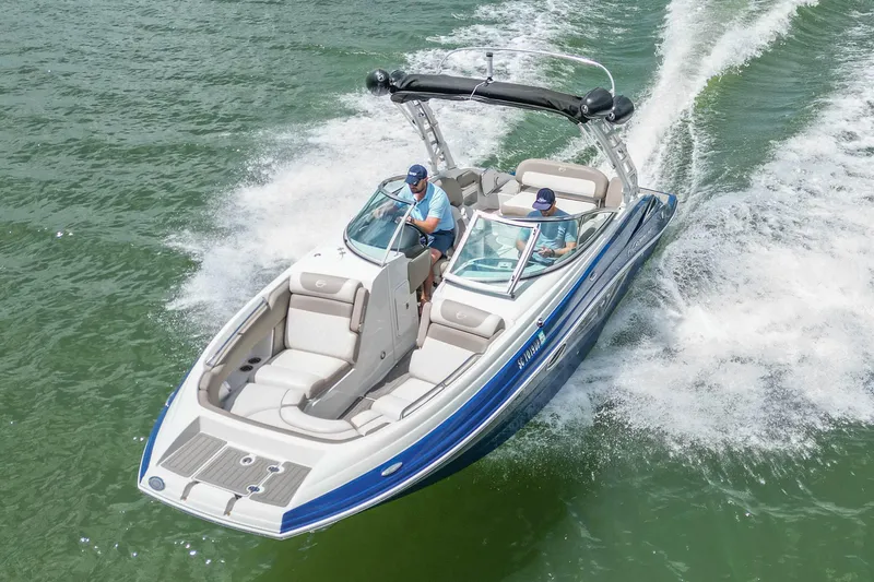 Slide: The Image of 2019 Crownline Eclipse E255 SURF boat cruising on open water. - 8