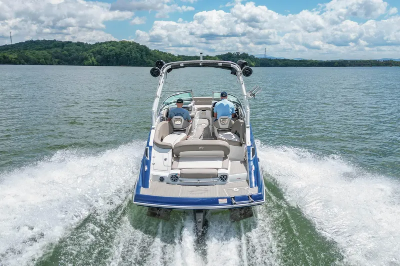 Slide: The Image of 2019 Crownline Eclipse E255 SURF boat cruising on a lake with two passengers. - 9