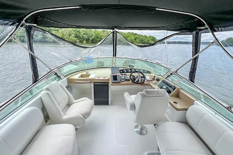 Slide: The Image of 2002 Carver 350 Mariner yacht interior with helm, seating, and lake view. - 11