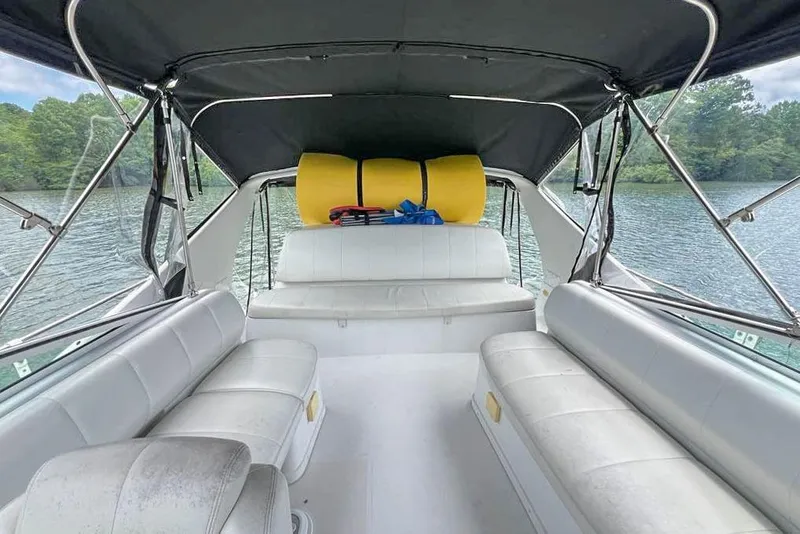 Slide: The Image of 2002 Carver 350 Mariner interior with white seating, lake view, and canopy. - 14