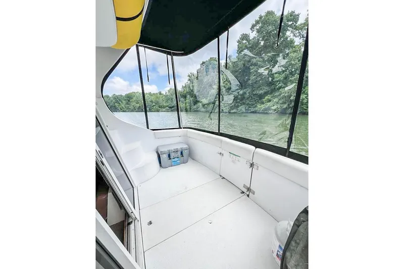 Slide: The Image of 2002 Carver 350 Mariner boat interior with river view and lush greenery. - 15