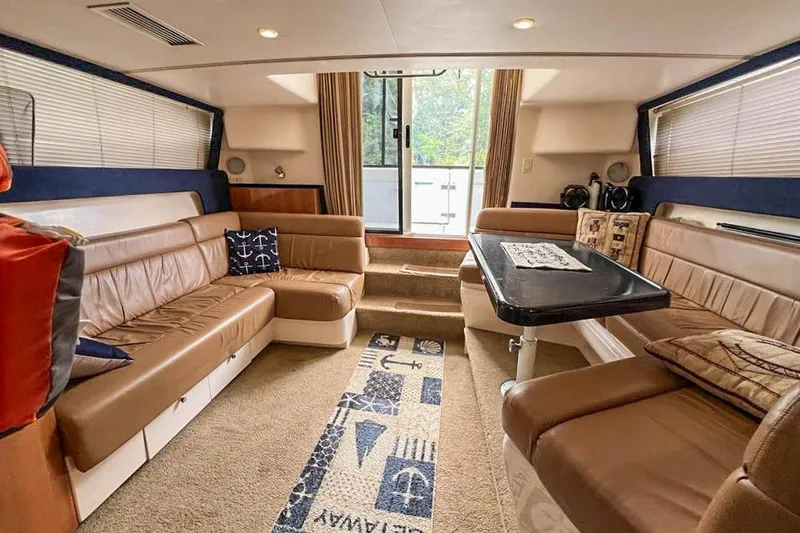 Slide: The Image of Luxurious interior of 2002 Carver 350 Mariner yacht with plush seating and nautical decor. - 17