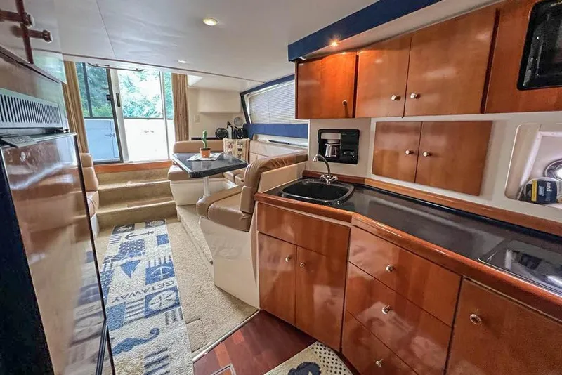 Slide: The Image of Interior of 2002 Carver 350 Mariner yacht with wood cabinetry and dining area. - 18