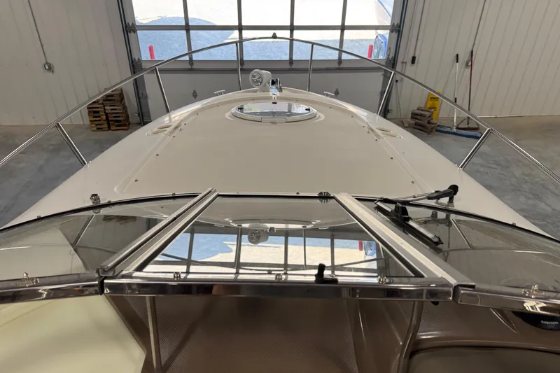 Slide: The Image of 2005 Regal Commodore 2665 boat in a garage, viewed from the bow. - 12