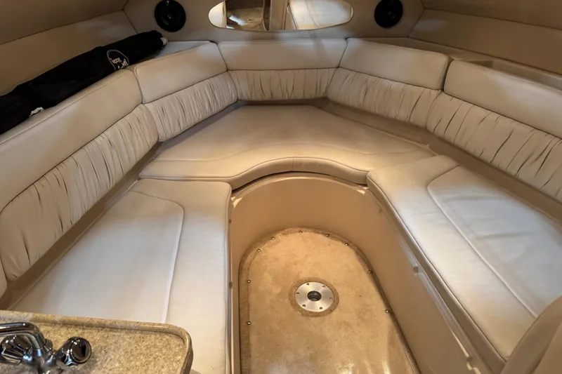 Slide: The Image of Interior of a 2005 Regal Commodore 2665 boat with beige seating and compact design. - 15