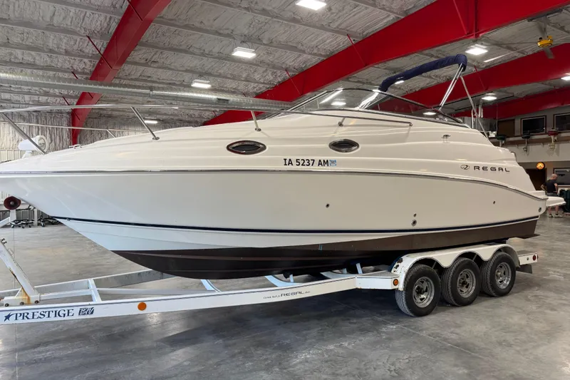 Slide: The Image of 2005 Regal Commodore 2665 boat on trailer in indoor storage facility. - 17