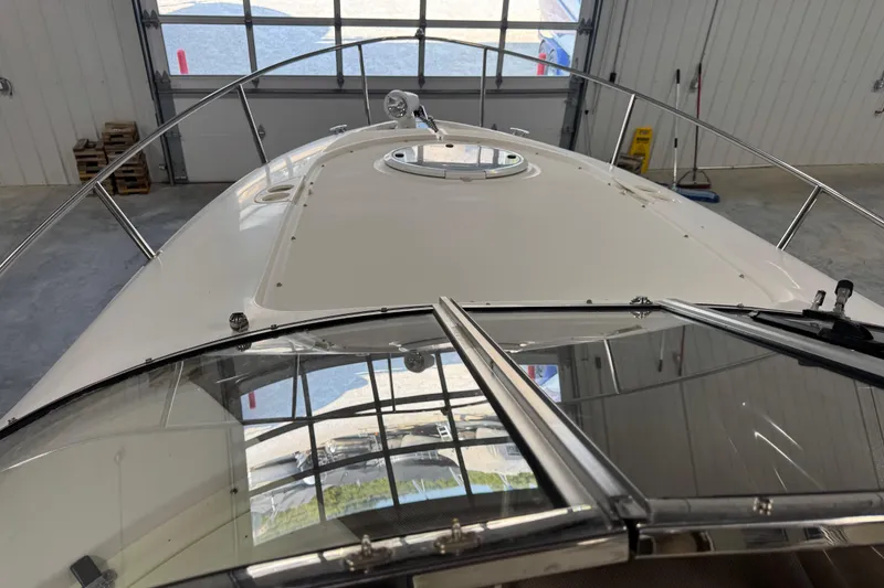 Slide: The Image of 2005 Regal Commodore 2665 boat in a garage, viewed from the bow. - 22