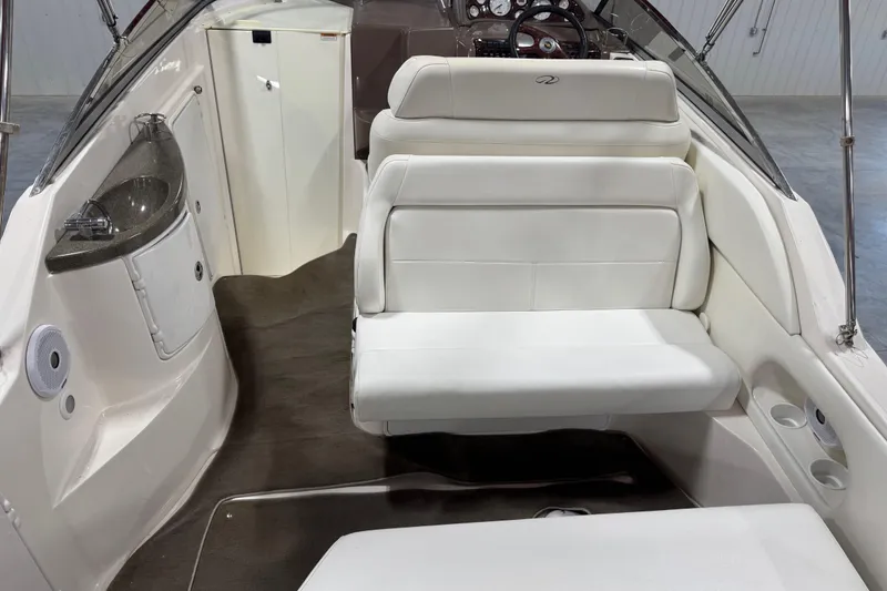 Slide: The Image of 2005 Regal Commodore 2665 boat interior with white seating and compact sink area. - 24