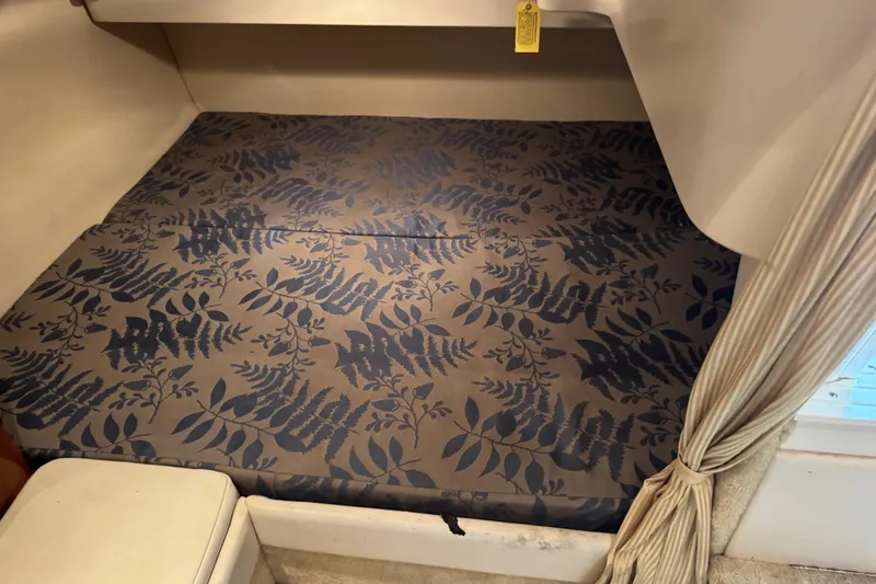 Slide: The Image of Interior cabin bed with floral-patterned bedding in a 2005 Regal Commodore 2665 boat. - 29