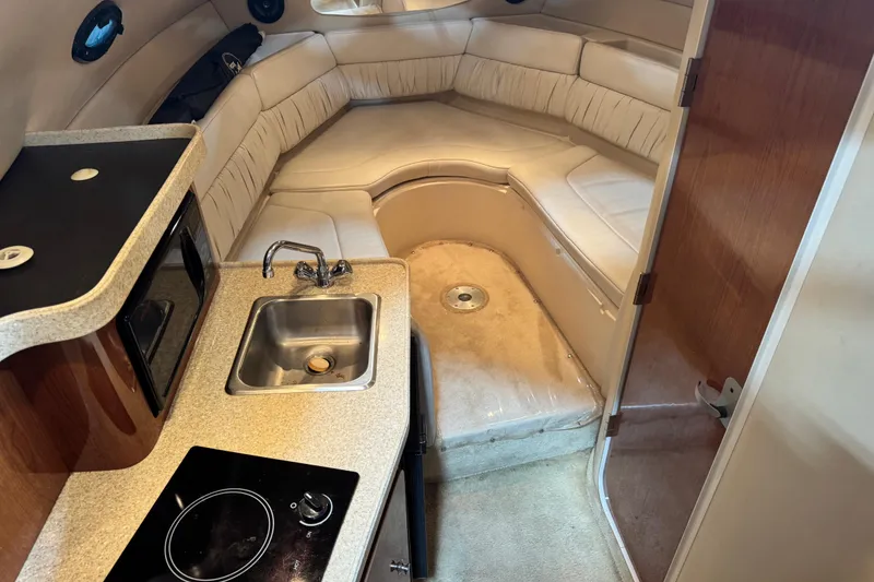 Slide: The Image of Interior of 2005 Regal Commodore 2665 boat with kitchenette and seating area. - 30