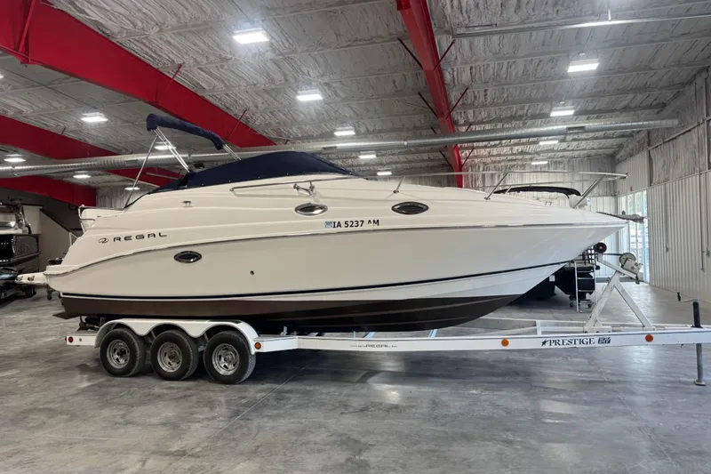 Slide: The Image of 2005 Regal Commodore 2665 boat on trailer in indoor storage facility. - 31