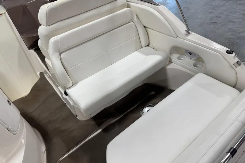 Slide: The Image of 2005 Regal Commodore 2665 boat interior with white seating and cup holders. - 7