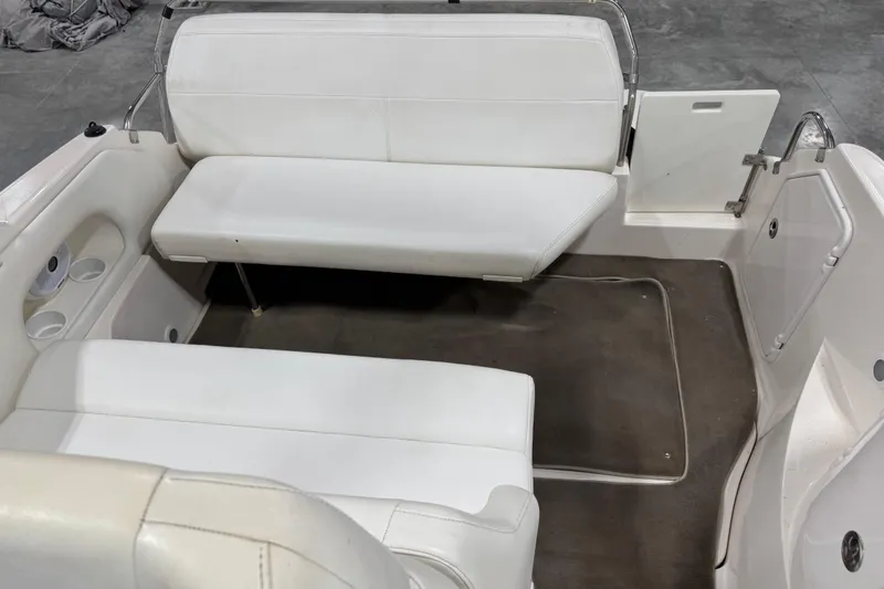 Slide: The Image of 2005 Regal Commodore 2665 boat interior with white seating and cup holders. - 9