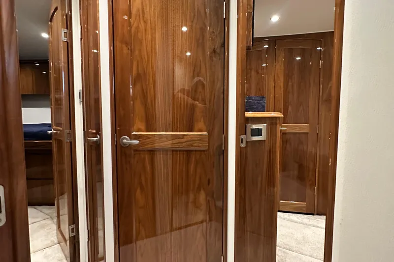 Slide: The Image of Luxurious wooden interior of 2017 Viking 55 Convertible yacht, featuring elegant doors and modern design. - 100