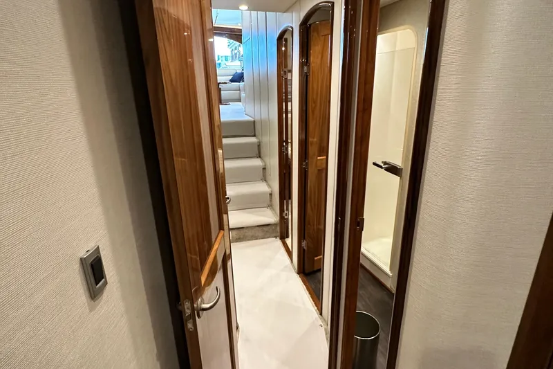Slide: The Image of Interior hallway of 2017 Viking 55 Convertible yacht with wooden doors and stairs. - 102