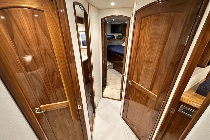 Slide: The Image of Interior hallway of 2017 Viking 55 Convertible yacht with wooden doors and cozy cabin. - 104