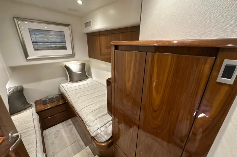 Slide: The Image of Luxurious cabin interior of 2017 Viking 55 Convertible yacht with twin beds and elegant wood finish. - 106