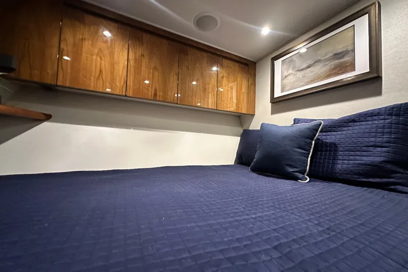Slide: The Image of Luxurious cabin interior of 2017 Viking 55 Convertible yacht with navy bedding. - 119