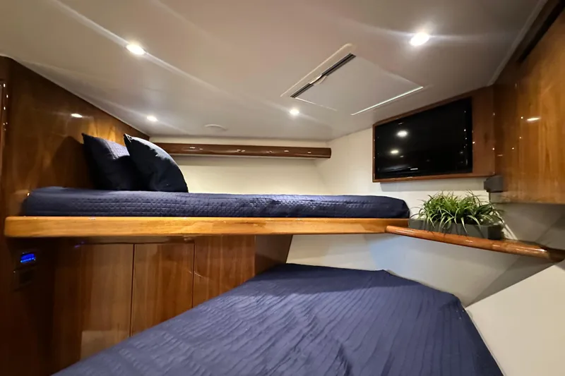 Slide: The Image of Luxurious cabin interior of 2017 Viking 55 Convertible yacht with cozy bedding and TV. - 120