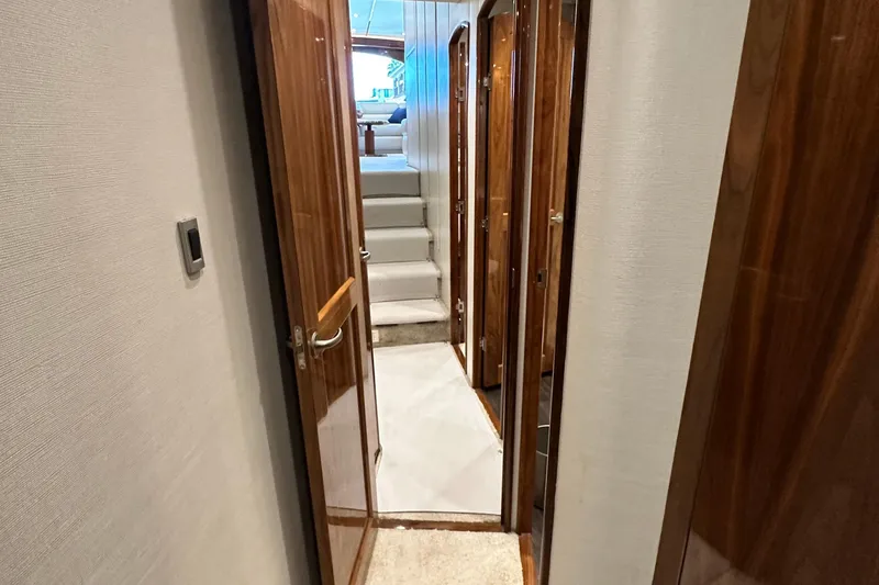 Slide: The Image of Hallway inside 2017 Viking 55 Convertible yacht with wooden doors and carpeted stairs. - 122