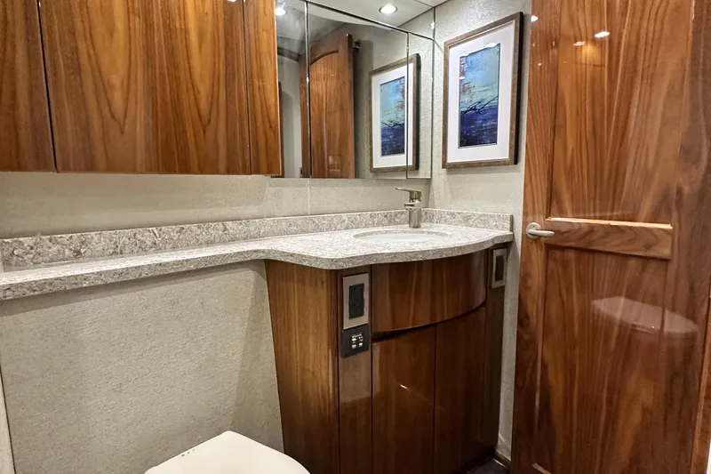 Slide: The Image of Luxurious bathroom interior of 2017 Viking 55 Convertible yacht with wood cabinetry and modern fixtures. - 124