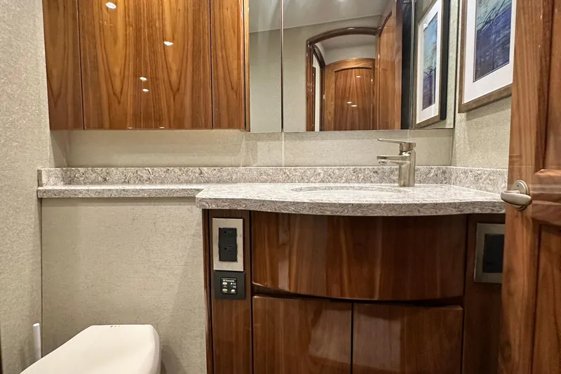 Slide: The Image of Luxurious bathroom in 2017 Viking 55 Convertible yacht with wood cabinetry and modern fixtures. - 127