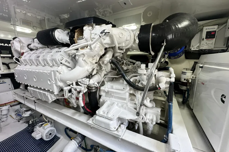 Slide: The Image of Engine room of 2017 Viking 55 Convertible yacht, featuring a powerful marine engine. - 130