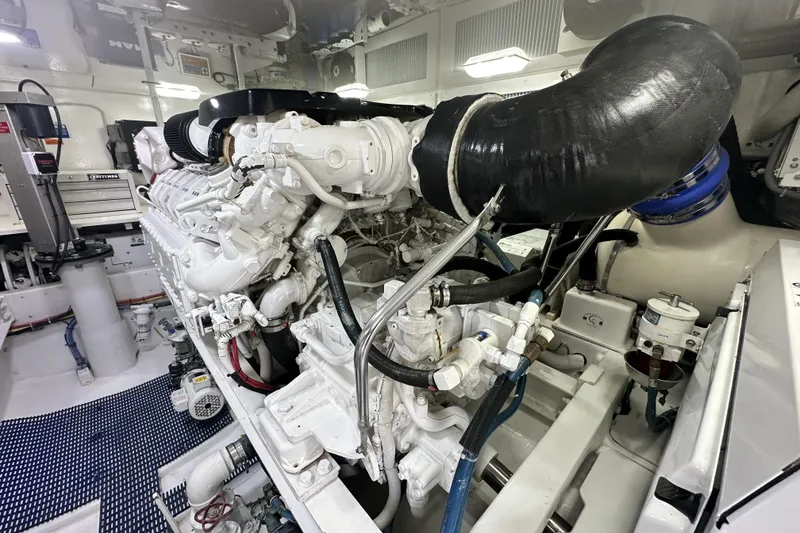 Slide: The Image of Engine room of 2017 Viking 55 Convertible yacht, showcasing detailed machinery and components. - 131