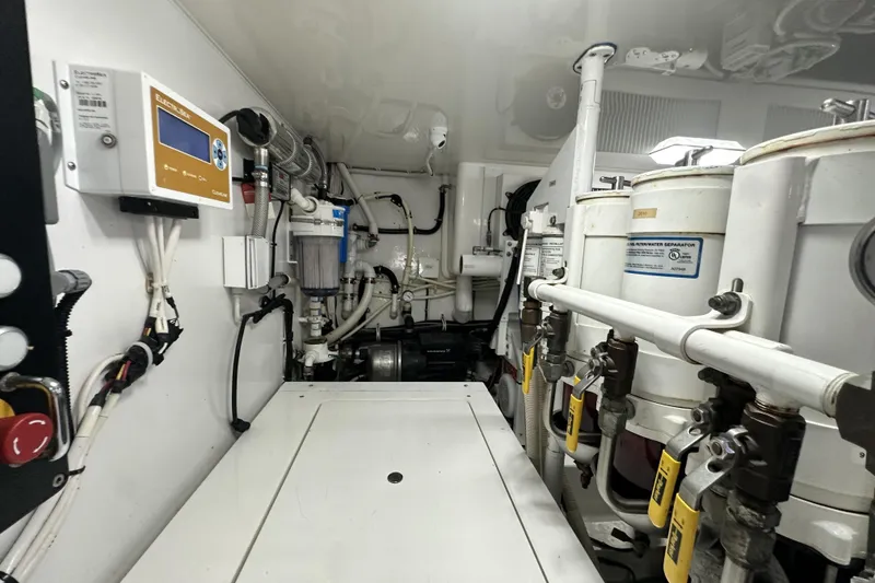 Slide: The Image of Engine room of 2017 Viking 55 Convertible yacht with fuel filters and control panel. - 140