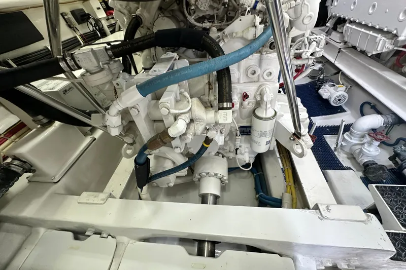 Slide: The Image of Engine room of 2017 Viking 55 Convertible yacht, showcasing mechanical components and piping. - 145