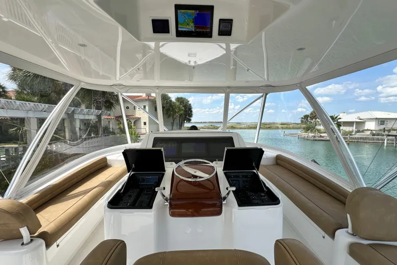 Slide: The Image of Interior view of 2017 Viking 55 Convertible yacht helm with navigation screens and seating. - 40