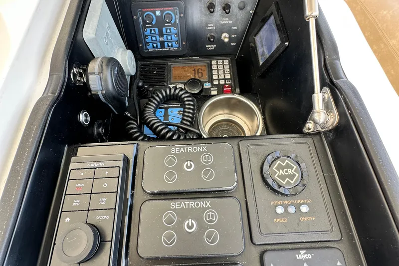 Slide: The Image of Control panel of a 2017 Viking 55 Convertible yacht with various navigation instruments. - 44