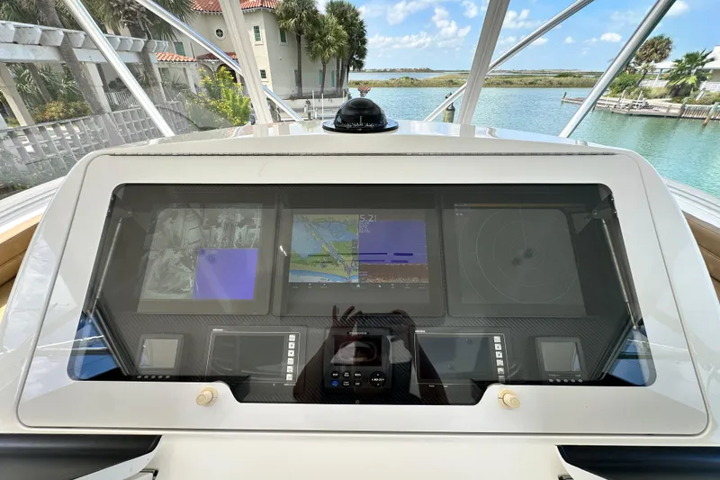 Slide: The Image of Cockpit dashboard of 2017 Viking 55 Convertible yacht with navigation screens. - 46