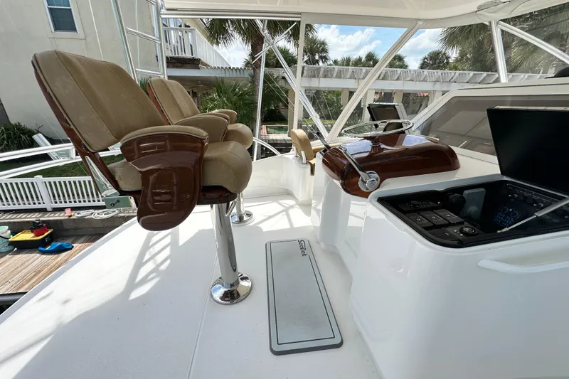 Slide: The Image of Luxurious helm of 2017 Viking 55 Convertible yacht with leather seats and modern controls. - 49