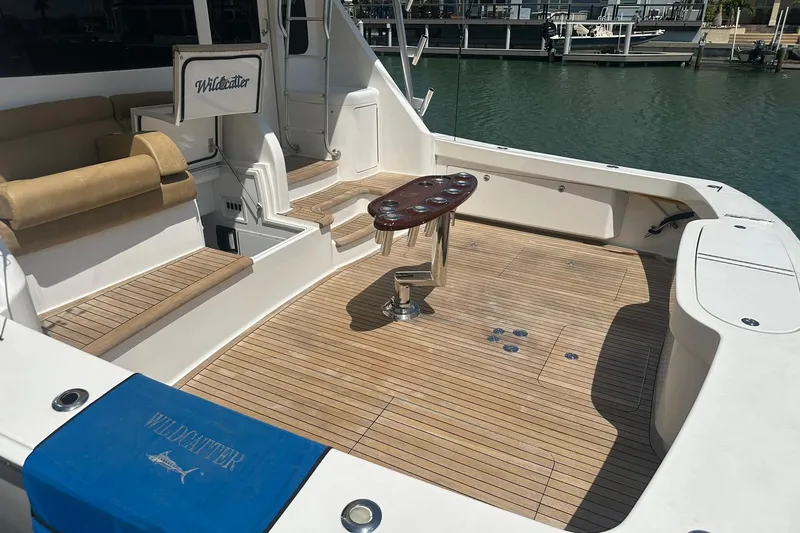 Slide: The Image of 2017 Viking 55 Convertible yacht deck with seating and fishing rod holders. - 51