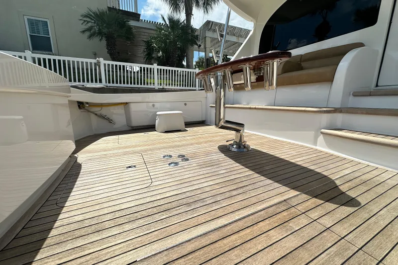 Slide: The Image of 2017 Viking 55 Convertible yacht deck with teak flooring and seating area. - 57